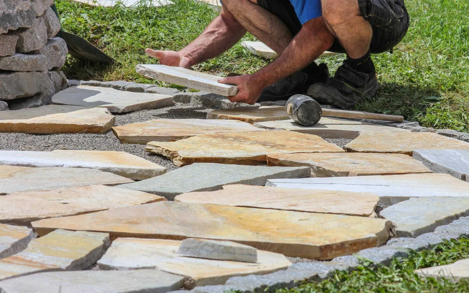 pavers installer setting marble pavers in place